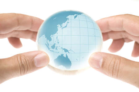 Child holding a globe in handsの写真素材