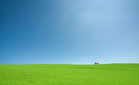 Green grass and red roof houseの写真素材
