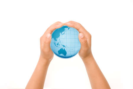 Child holding a globe in hands.の写真素材