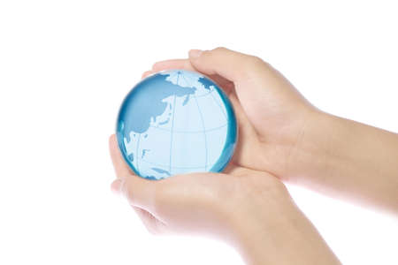 Child holding a globe in handsの写真素材
