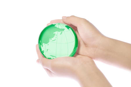Child holding a globe in handsの写真素材