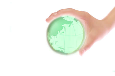 Child holding a globe in handの写真素材