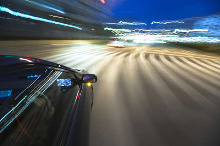 The car moves at great speed at the eveningの写真素材