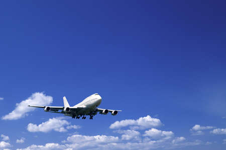 An airplane flying in the blue skyの写真素材
