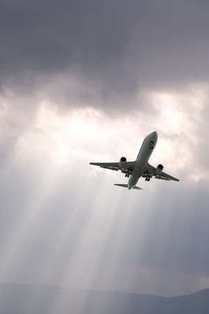An airplane flying in the blue skyの写真素材
