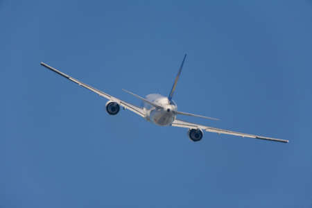 An airplane flying in the blue sky