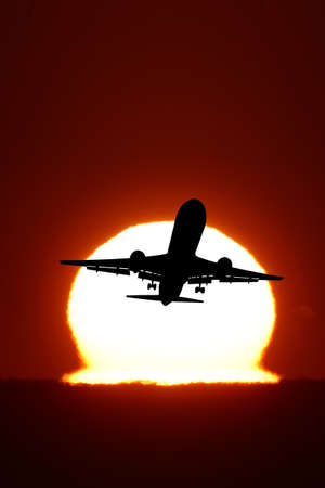 An airplane flying in the sunの写真素材