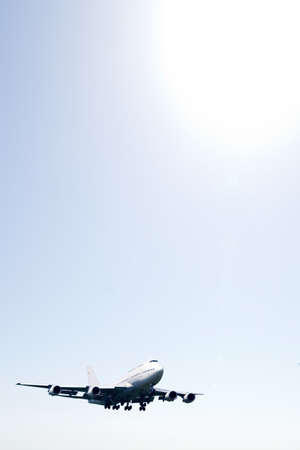 An airplane flying in the orange skyの写真素材