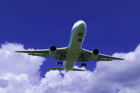 An airplane flying in the blue skyの写真素材