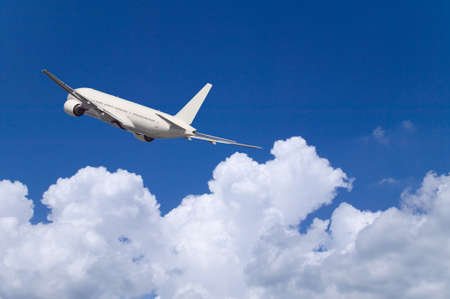 An airplane flying in the blue skyの写真素材