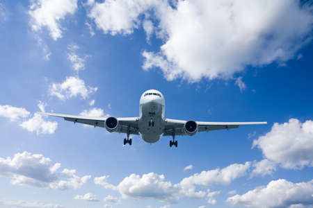 An airplane flying in the blue skyの写真素材