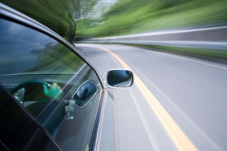 The car moves at great speed at the sunny day.の写真素材
