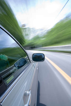 The car moves at great speed at the sunny day.の写真素材