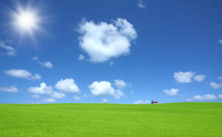 Green grass and red roof house and rainbow の写真素材