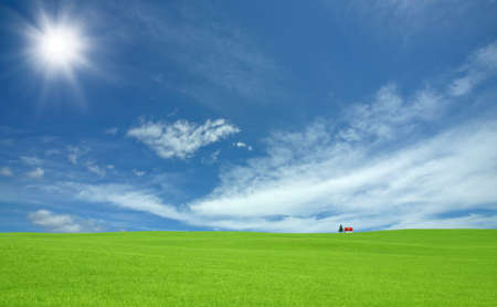 Green grass and red roof house and rainbow の写真素材