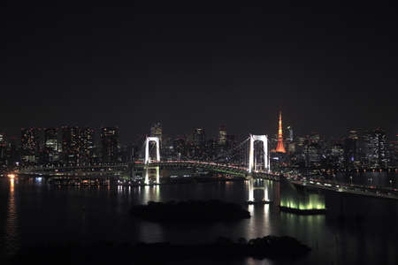 View of Tokyo downtown at night with Rainbow Bridge の写真素材
