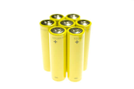 Gold battery in upright position with focus to the positive terminal at the topの写真素材