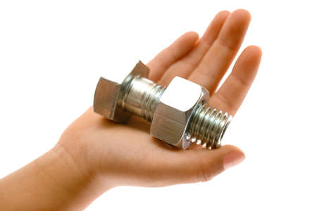 Hand holding a large silver metal bolt and nut over a white backgroundの写真素材