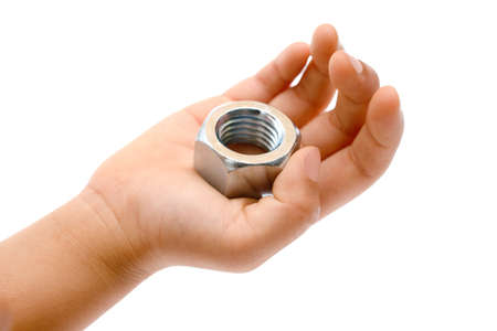 Hand holding a hexagonal silver metal nut over whiteの写真素材