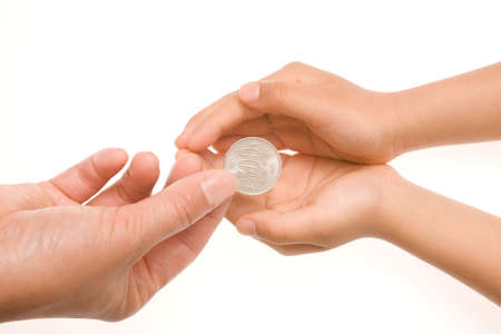 Handing a coin to someone on white backgroundの写真素材