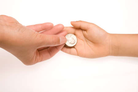 Handing a coin to someone on white backgroundの写真素材