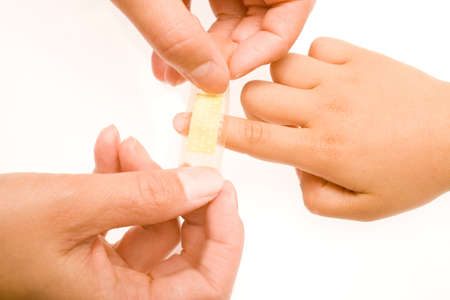 Sticking a patch on an injured fingerの写真素材