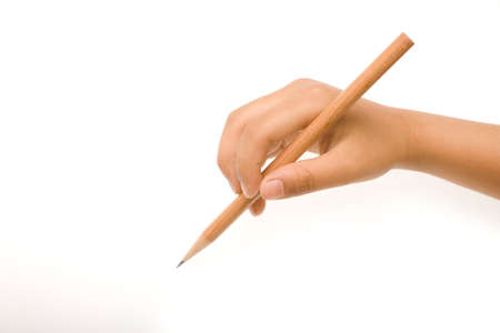 Hand holding a wooden pencil with sharpened lead over whiteの写真素材