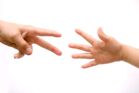 Two human hands stretching out towards one another over a white background in a concept of help and assistanceの写真素材