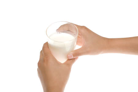 Two hands holding a glass of fresh milk isolated on whiteの写真素材