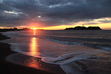 Cloud and shore and Enoshima of the morning glowの写真素材