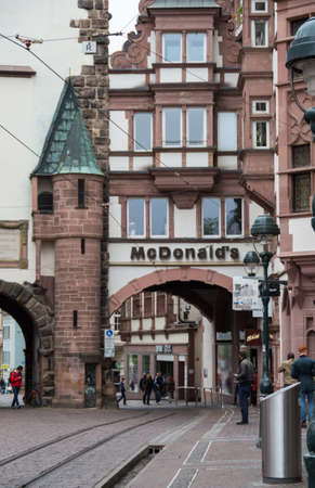 McDonalds restaurant name on an archway at Martinstor in Freiburg.のeditorial素材