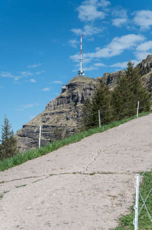 Red and white tower on top of mount rigi to signal the peak and flash at night for aircraft