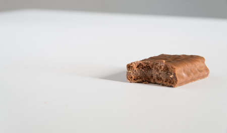 Iconic Australian hocolate biscuit with a bite taken on a whiteの写真素材