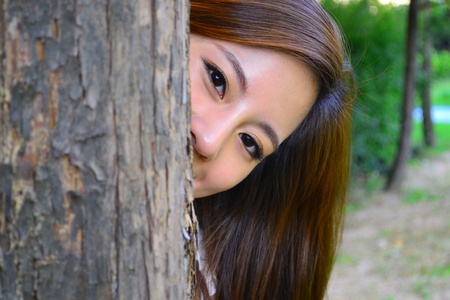 Hiding behind the tree の写真素材
