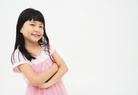 Beautiful asian child with her arms crossedの写真素材