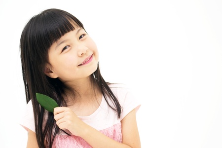 Beautiful asian girl with a leafの写真素材