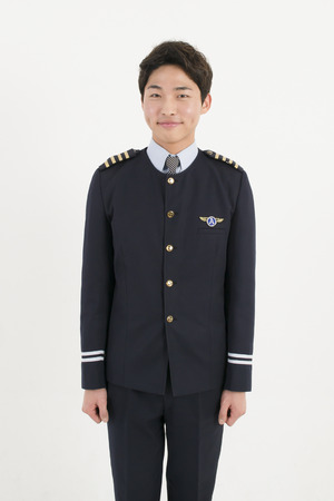 Asian airline pilot isolated on white backgroundの写真素材