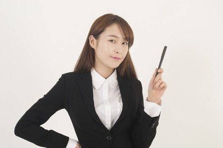 Attractive young asian businesswoman with a penの写真素材