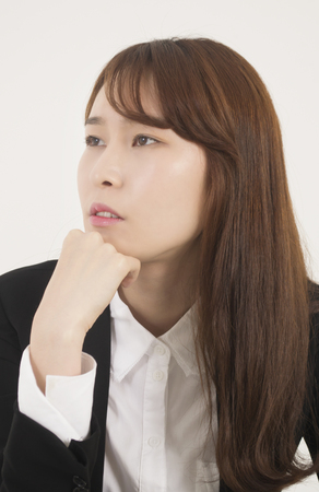 Beautiful young woman thinkingの写真素材