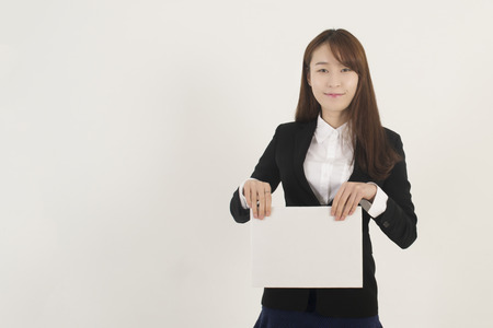 Young Asian Woman Holding a Blank White Signの写真素材