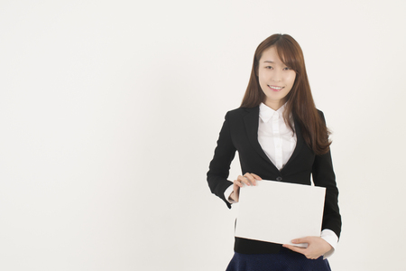 Young Asian Woman Holding a Blank White Signの写真素材