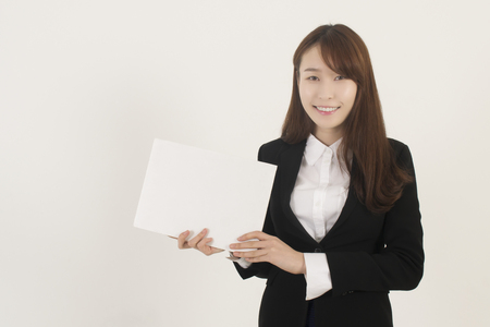 Young Asian Woman Holding a Blank White Signの写真素材