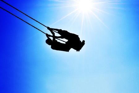 Two boys are flying in the skyの写真素材
