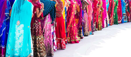 Many Indian women standing in long queueの写真素材