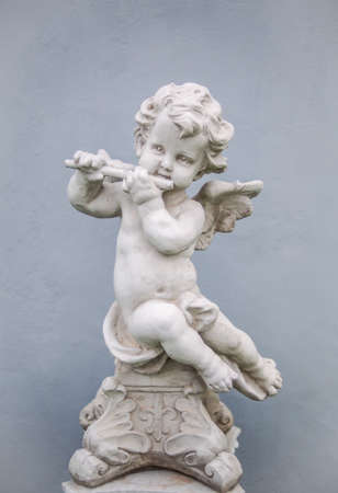 A cupid statue playing flute on the rooftop of a residence in Khao Yai, Thailandの素材