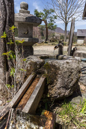 Traditional Japanese fountain in the fieldの写真素材