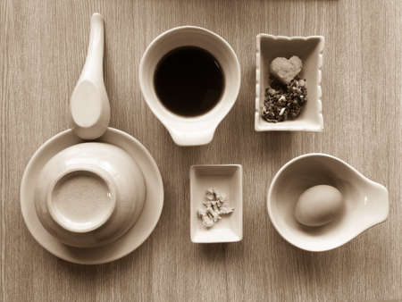 Stylish dining set arrangement for shabu shabu with sauce and condiments in sepiaの写真素材