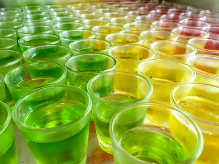 Jelly dessert in apple (green), lemon (yellow), and strawberry (red)の写真素材