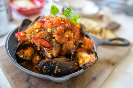 Blue mussel baked in tomato sauceの写真素材