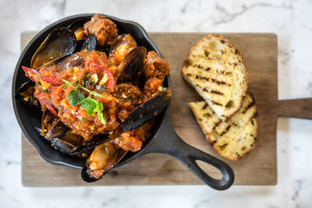 Blue mussel baked in tomato sauceの写真素材